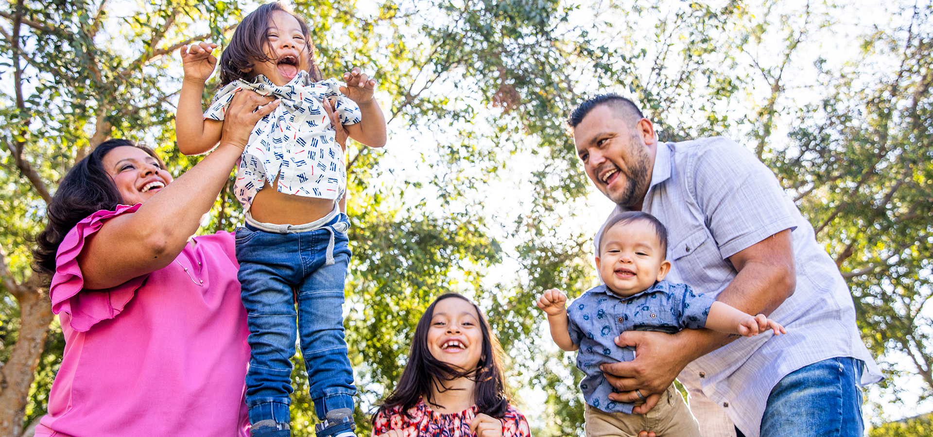 Happy Latino family enjoying family time outdoors